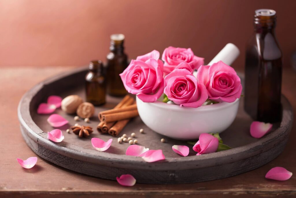 essential oils with spices and roses in mortar and pestle 2