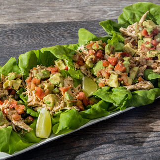 A plate of food with lettuce and meat on it.