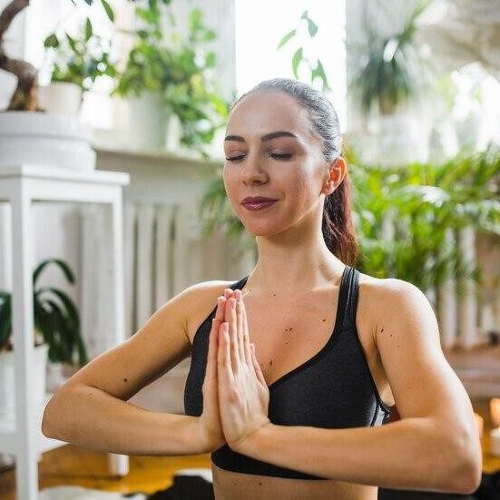 girl sitting in a yoga pose in a tranquil setting